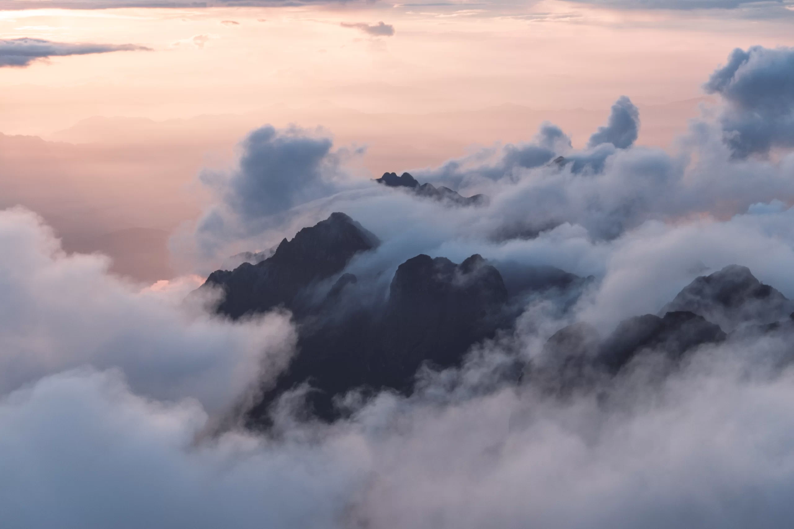 andreas-kind-above the clouds image unsplash