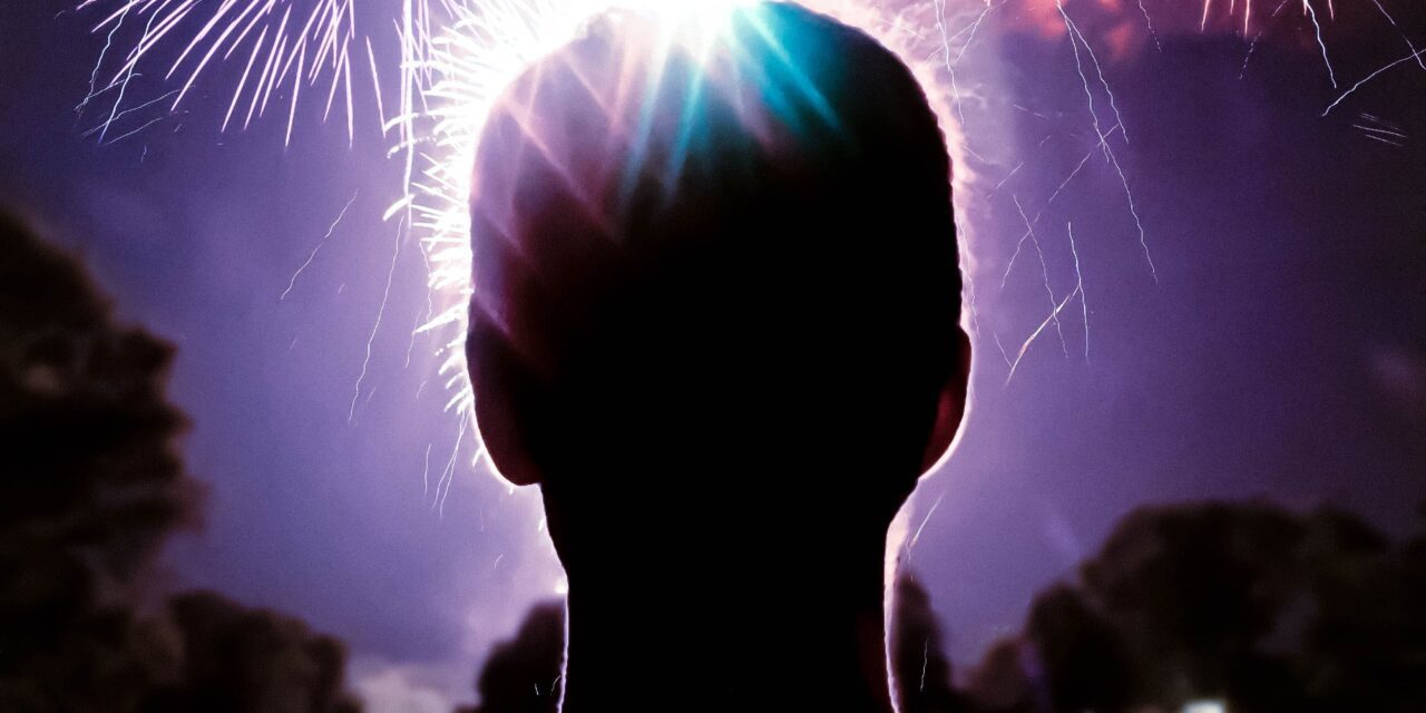 spenser-sembrat-man in foreground looking at fireworks display-unsplash