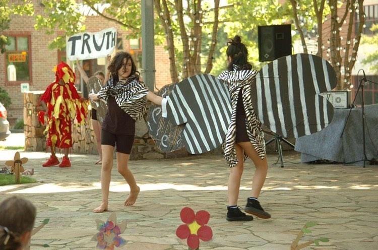 123 Puppetry performance at Southern Village, Spring 2019-see the light. Featured Puppeteers actors Zola Ramirez and Fernanda Topete wearing moth wings for the Spring 2019 See the Light while puppeteers in fire costumes dance on each side of the stage