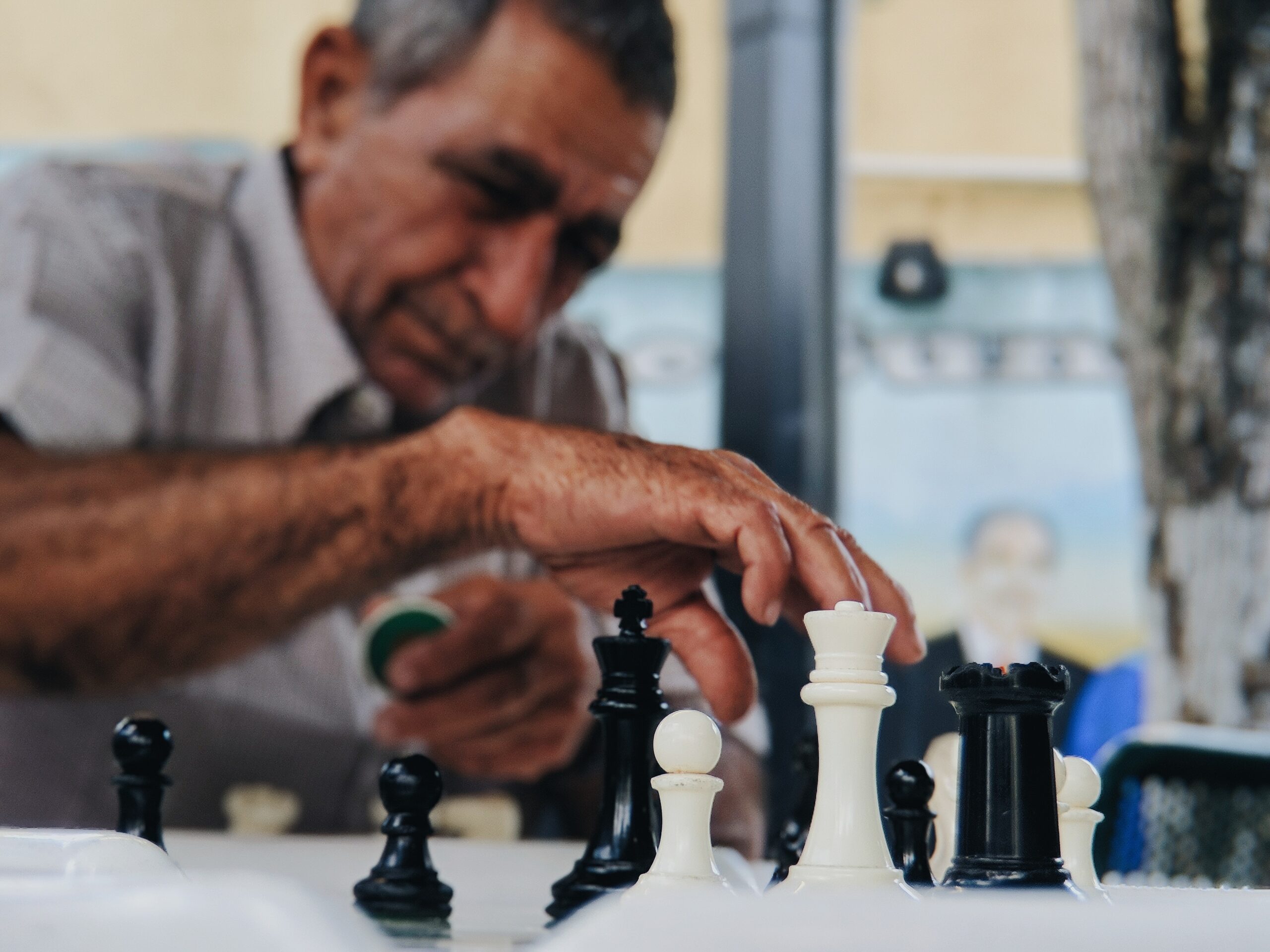 juno-jo-Man outdoor park chess board moving piece-unsplash (1