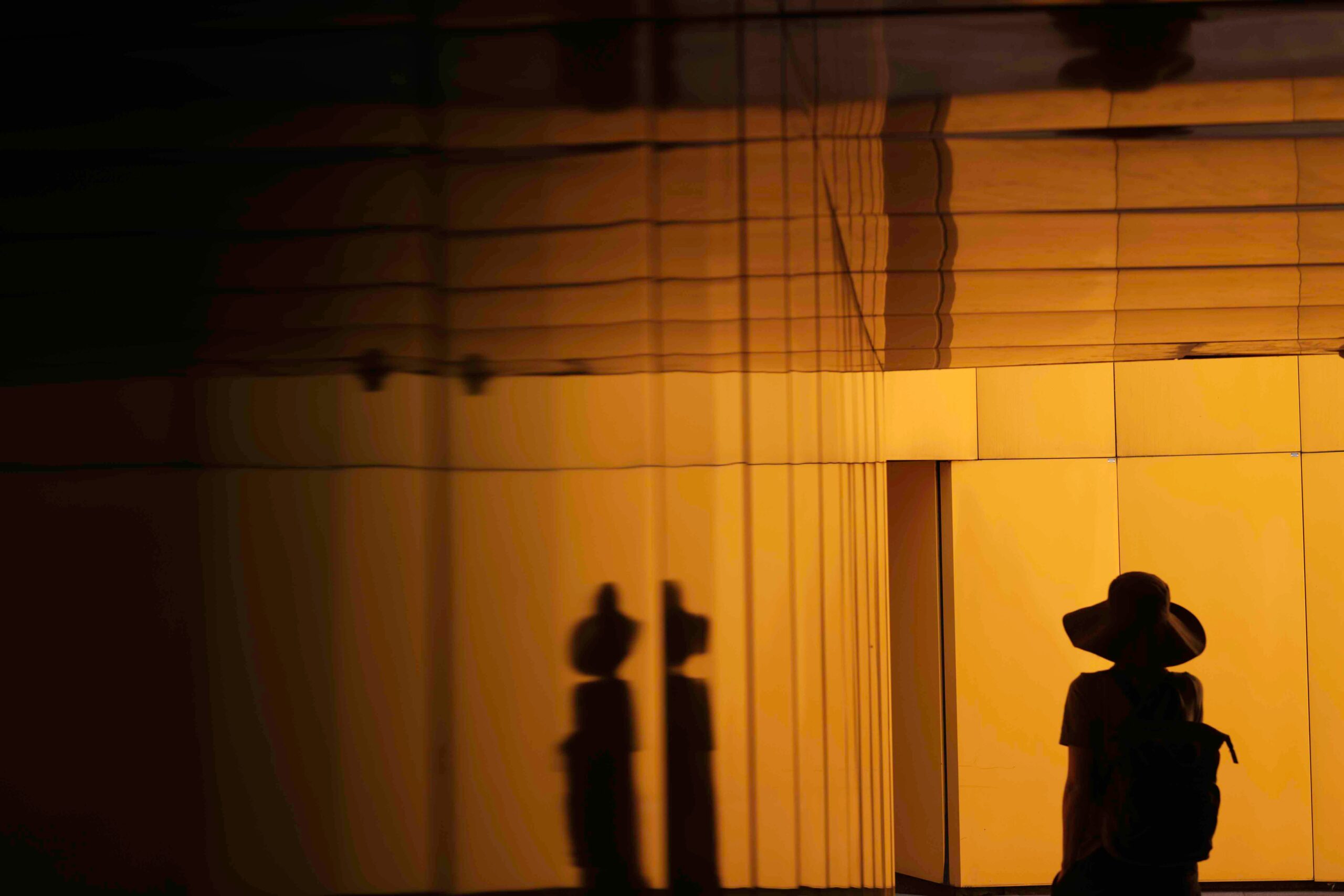 Brandon Wong image from Unsplash woman in black with black hat reflected 