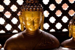 jeff-ackley-Golden Buddha head with Rosewood lattice background-unsplash