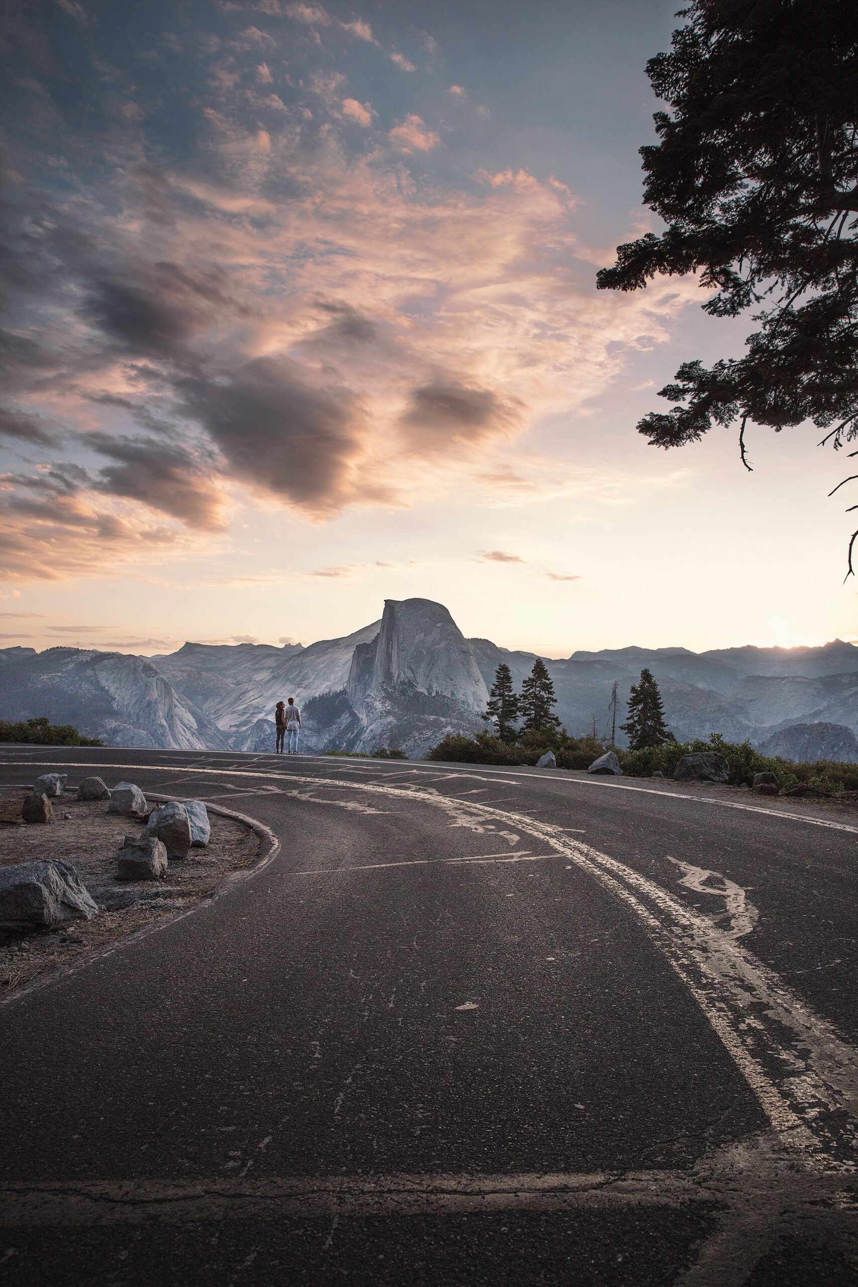 joshua-earle-couple walking on highway shoulder-unsplash