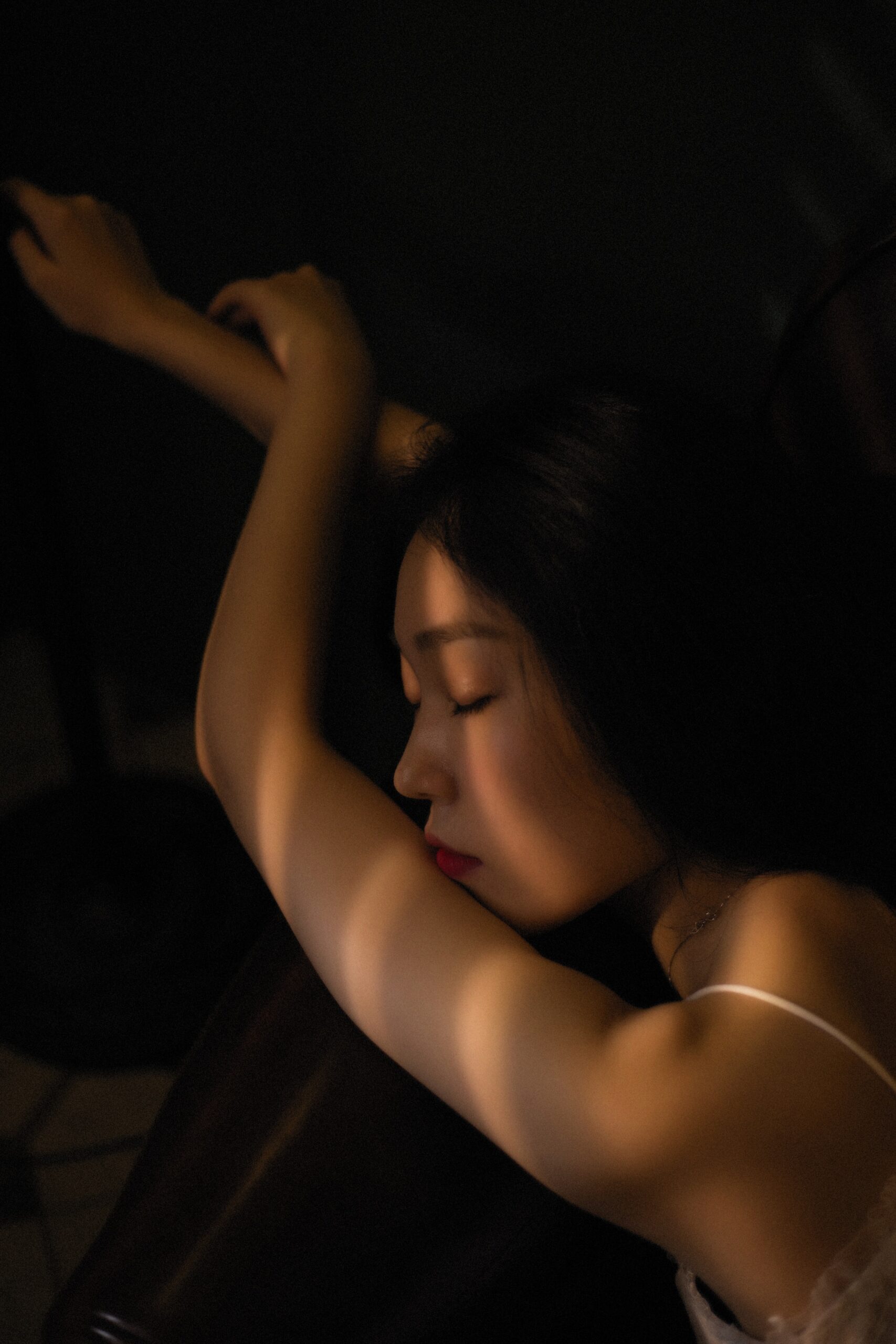 Woman sleeping on brown sheets