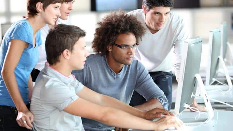 Students around a monitor moocs-istockphoto-goodluz-1