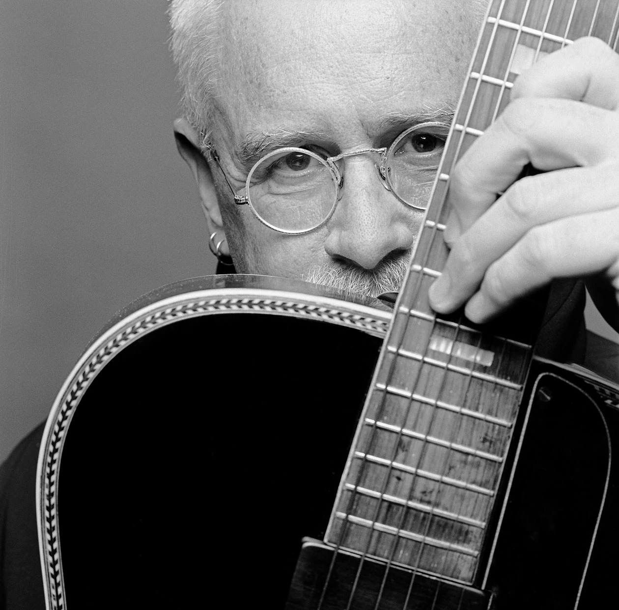 Bruce-Cockburn_COCKBURN-HOLDING-GUITAR_No-photo-credit-given_WEB