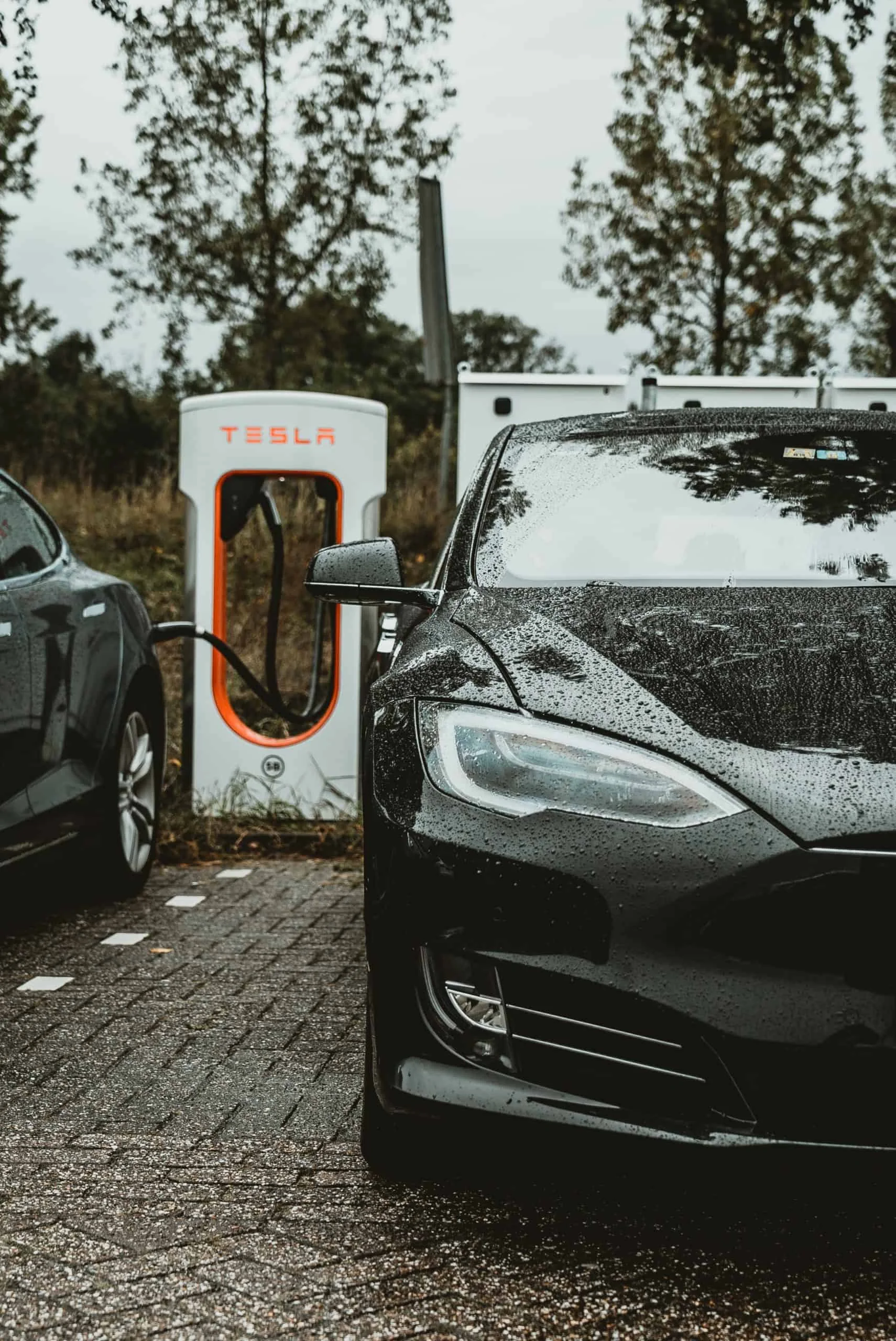 andreas-dress-Tesla Model 3 charging at Tesla powerstation-unsplash-1-scaled