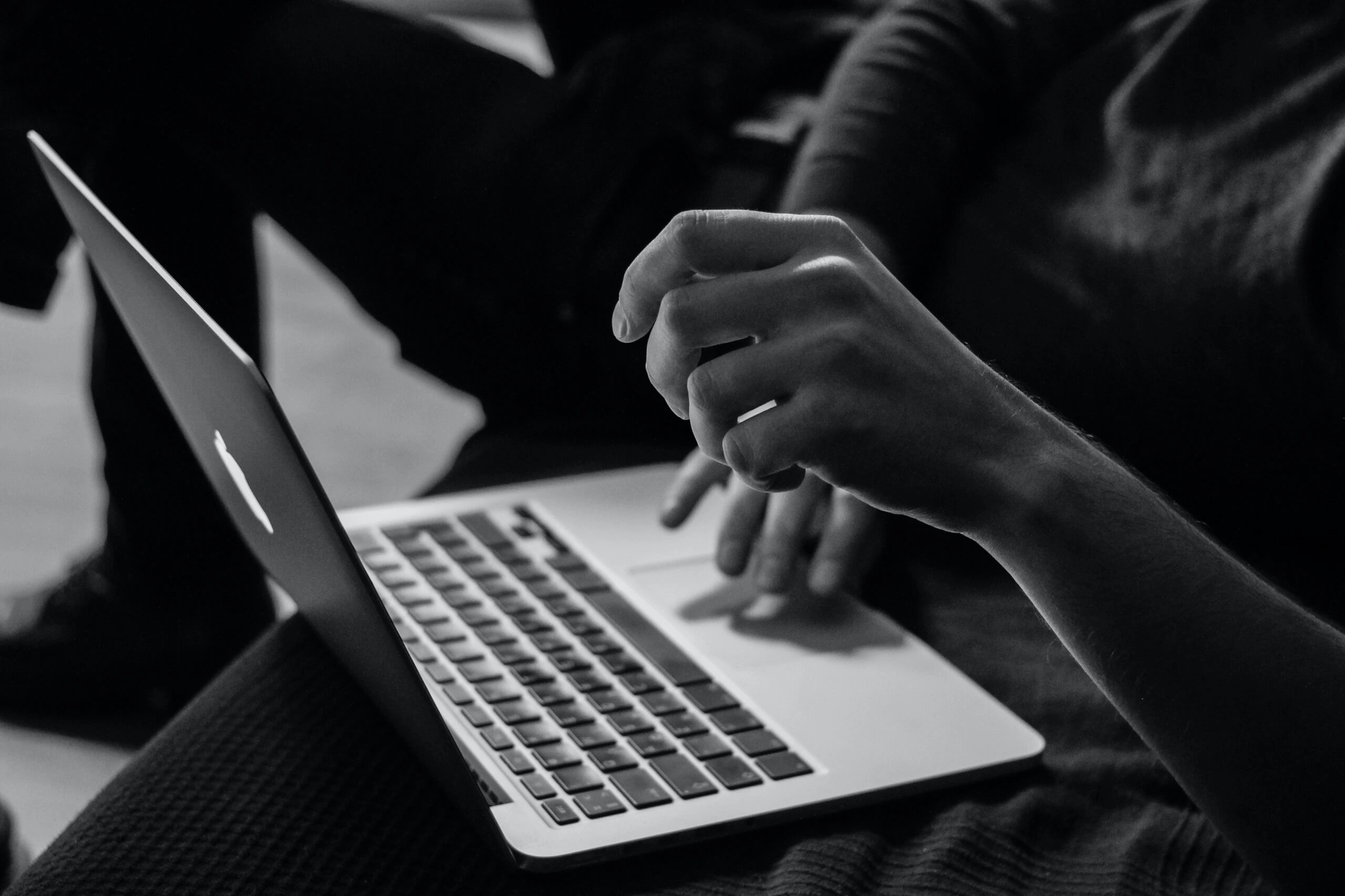 sergey-zolkin-Student with Apple Macbook pro-unsplash-scaled
