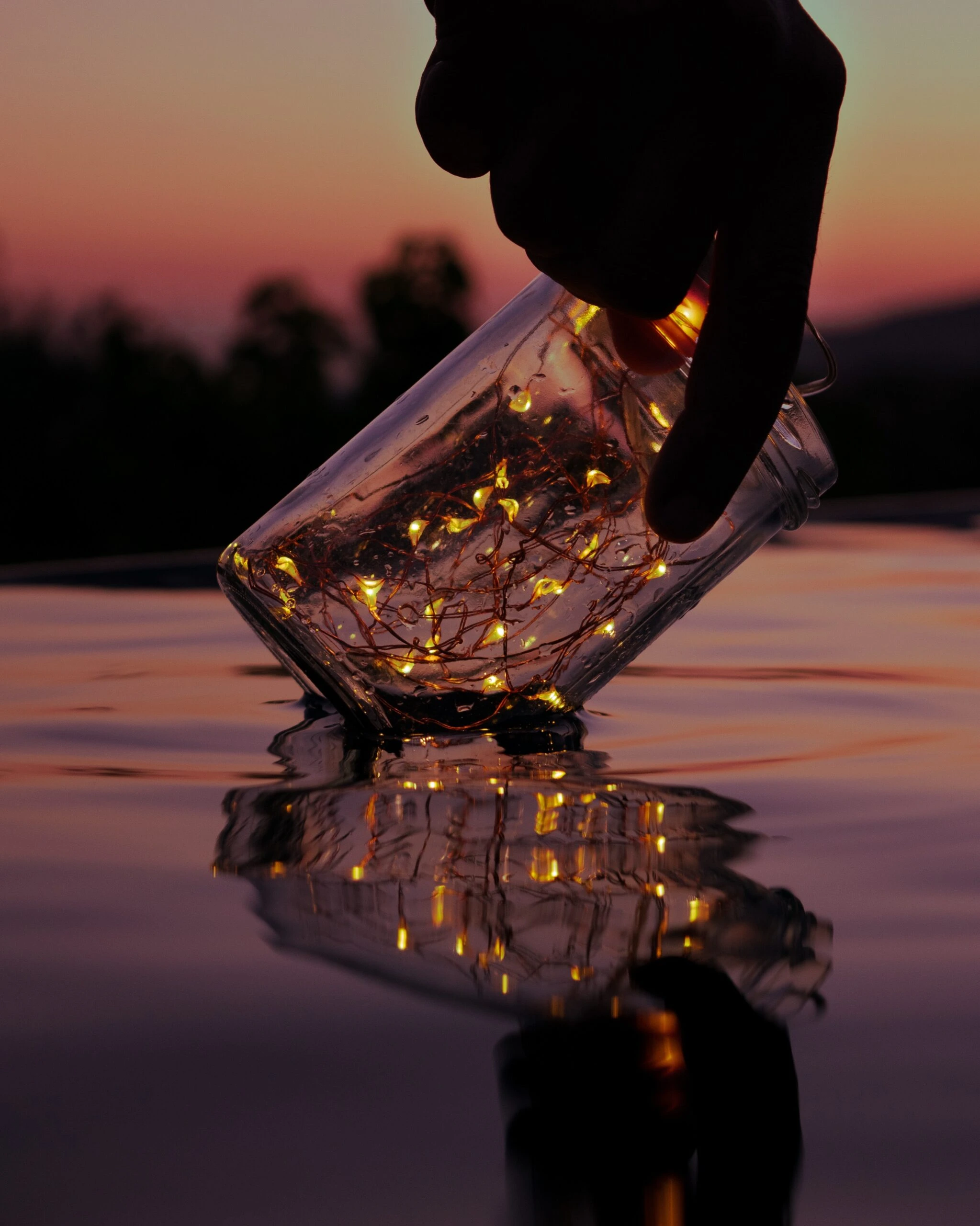 luigi-colonna-string of lights in a jar at evening dipping in wade pool-unsplash-scaled