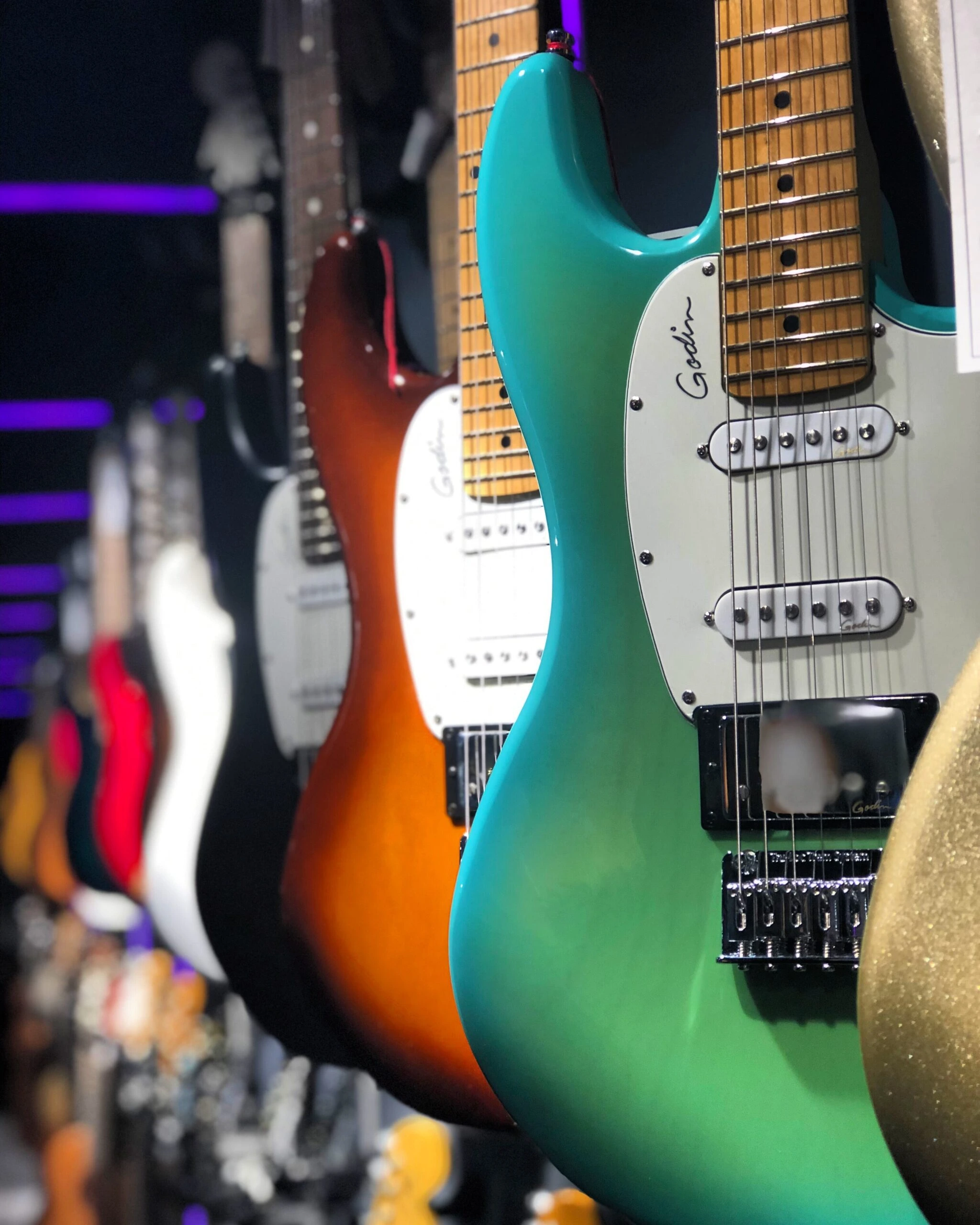 mohrez-labaf-Q5IO7kum-J8-unsplash Row of electric guitars in shop by Mohrez Labaf