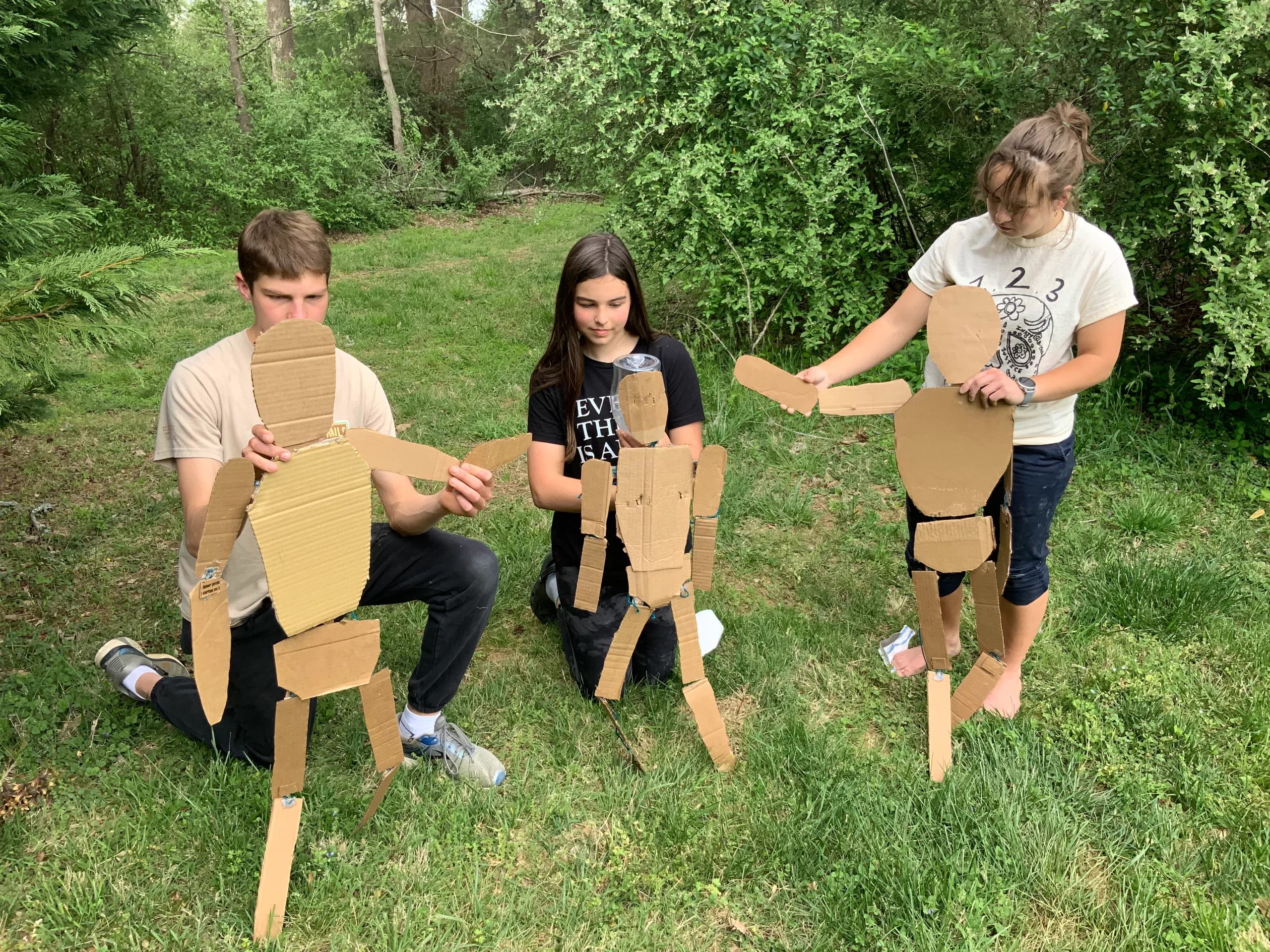 asper-Katie-and-Sophia-holding-up-first-stage-puppet-outlines-for-The-Time-We-Have-123-Puppetry-play-April-27-2002-prep-session-scaled