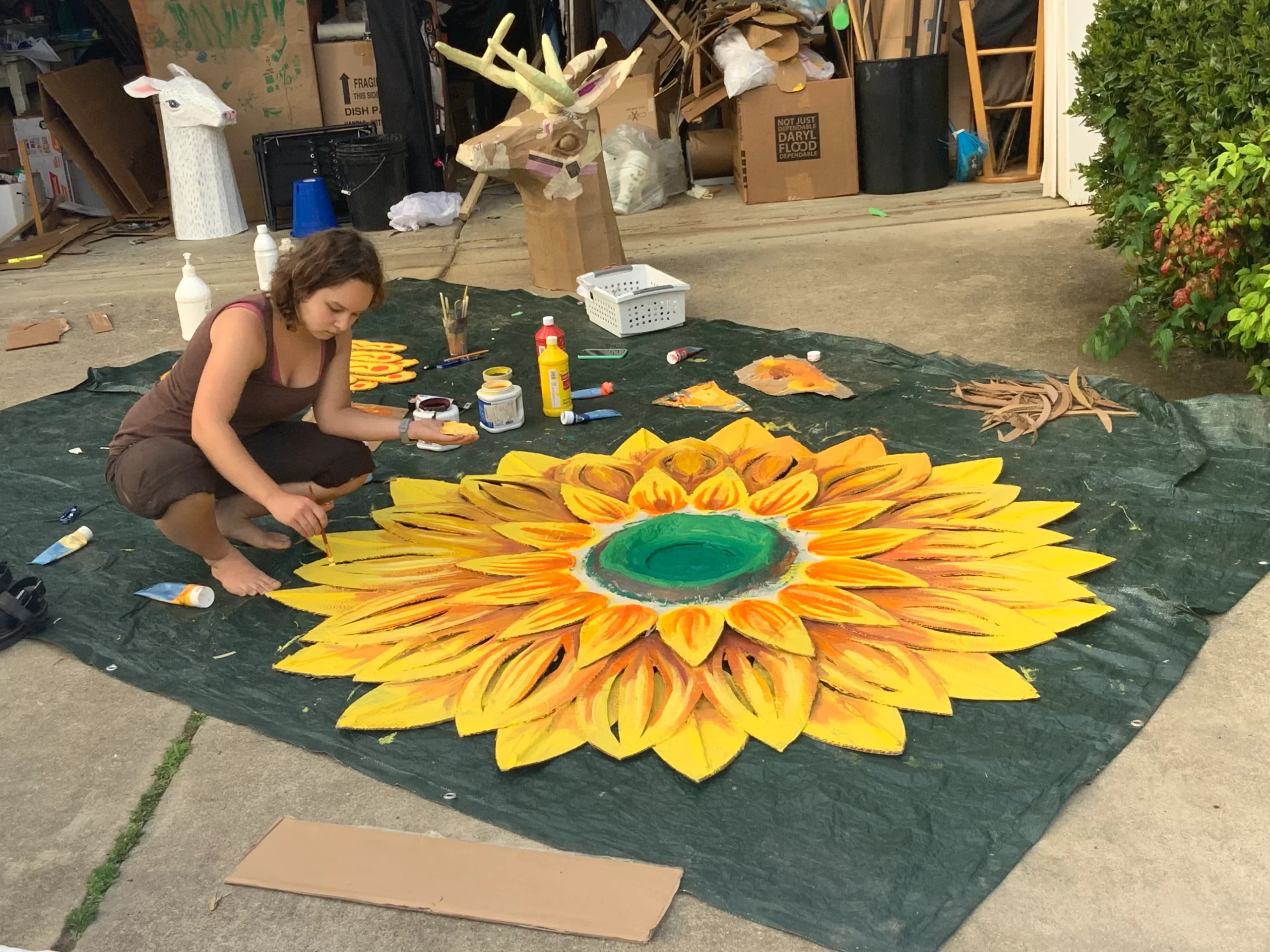 Sophia painting the Sun set piece for 1,2,3 Puppetry The Time We Have play