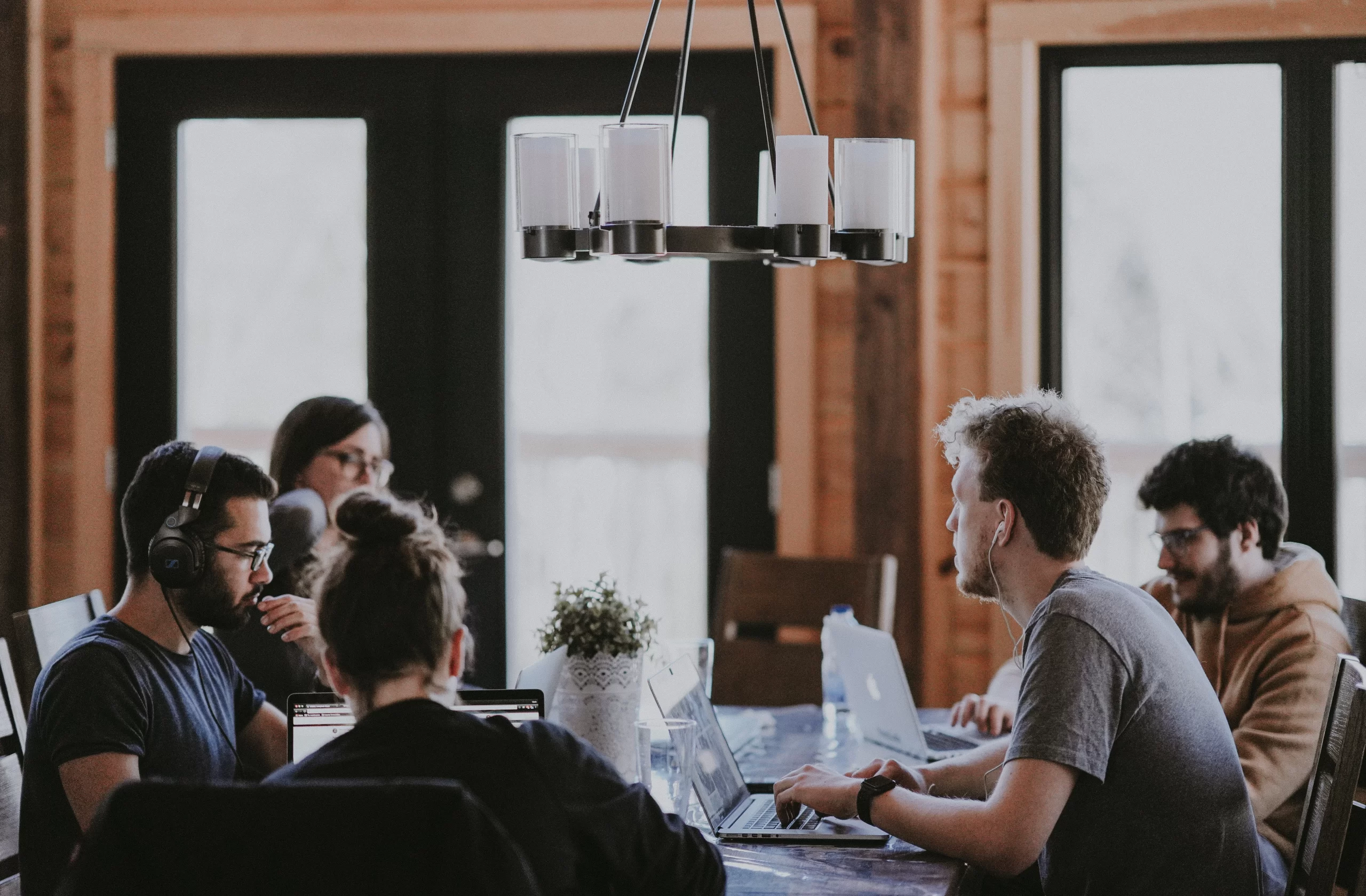 annie-spratt-Collegues around conference room table unsplash