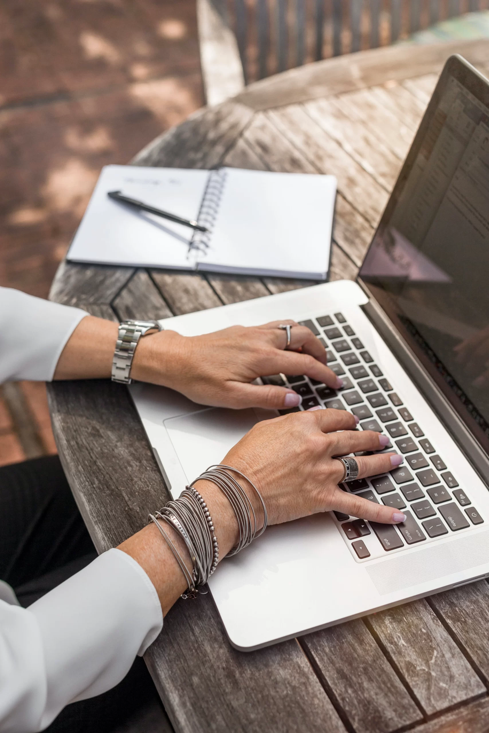 linkedin-sales-solutions Womans hands and arms at Laptop keyboard typing