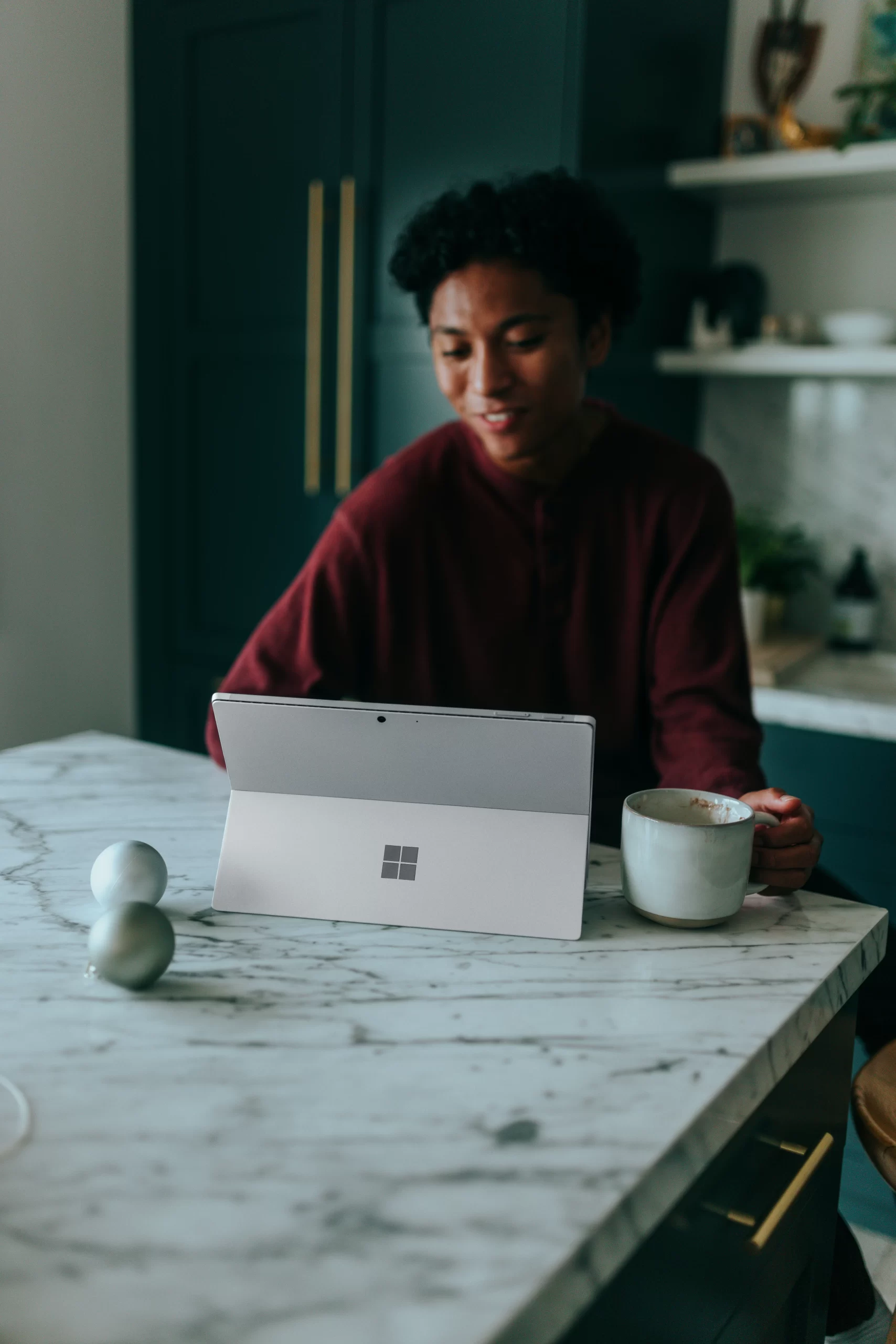 Young female student at kitchen counter top surface--unsplash