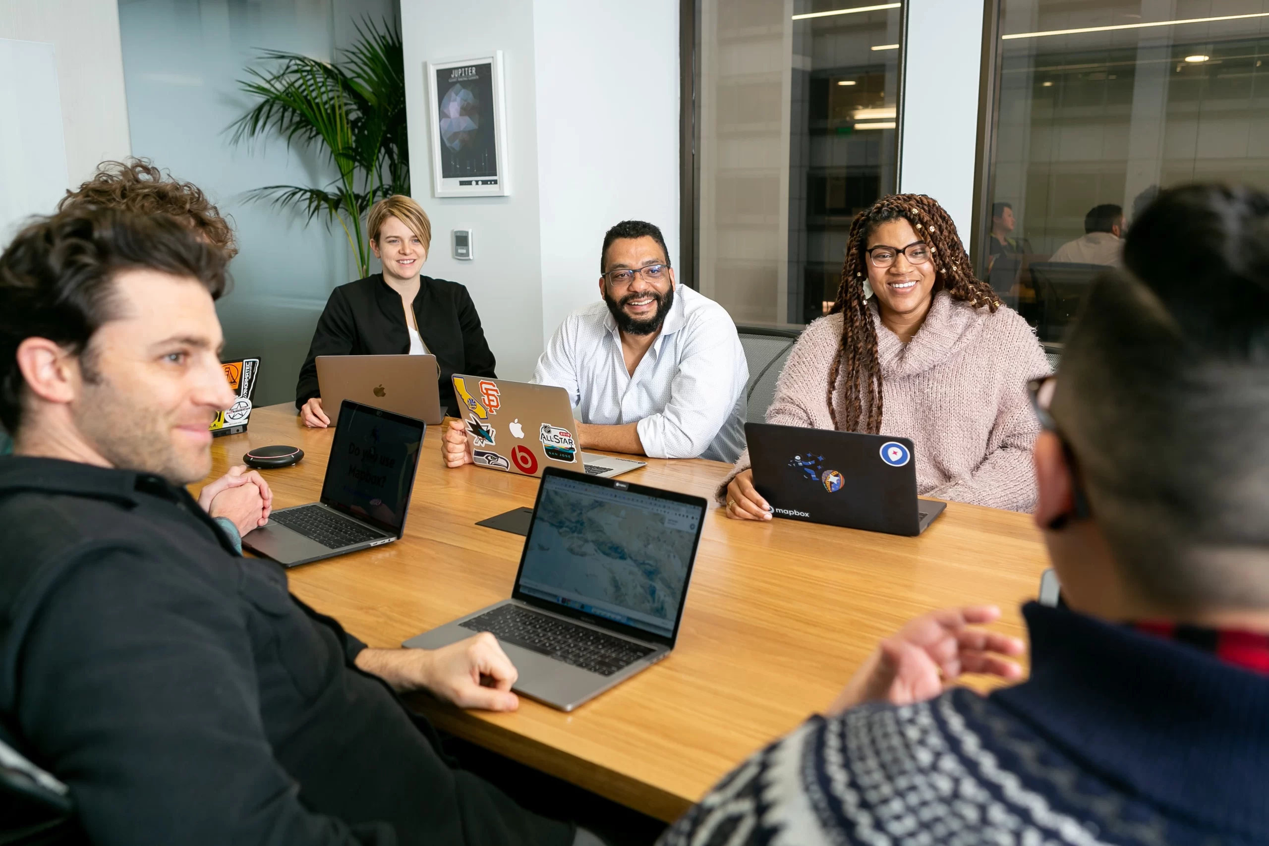mapbox-Developer team around conference table during meeting-unsplash