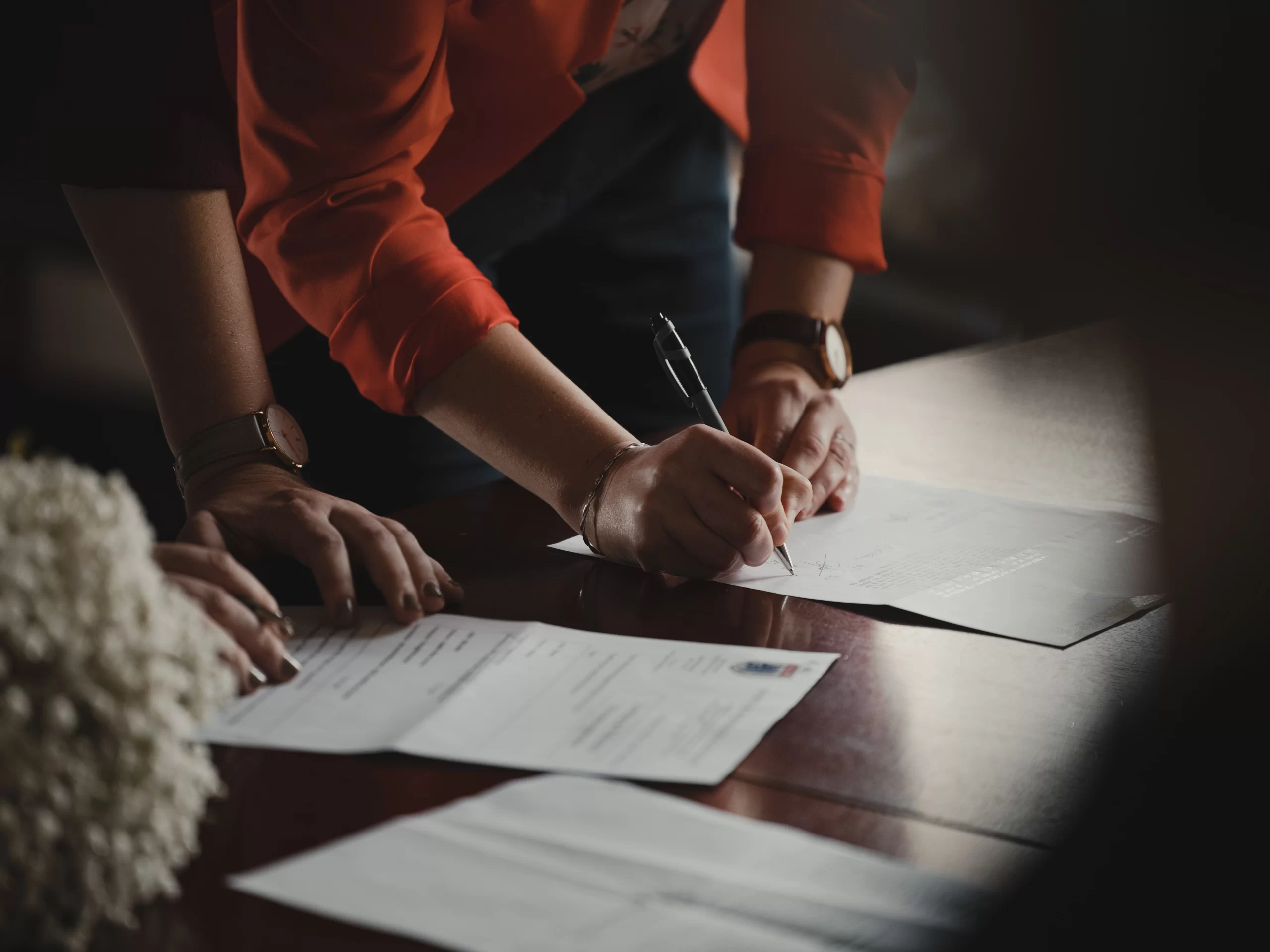 romain-dancre-Gentleman at conference table reviewing and signing contracts-unsplash