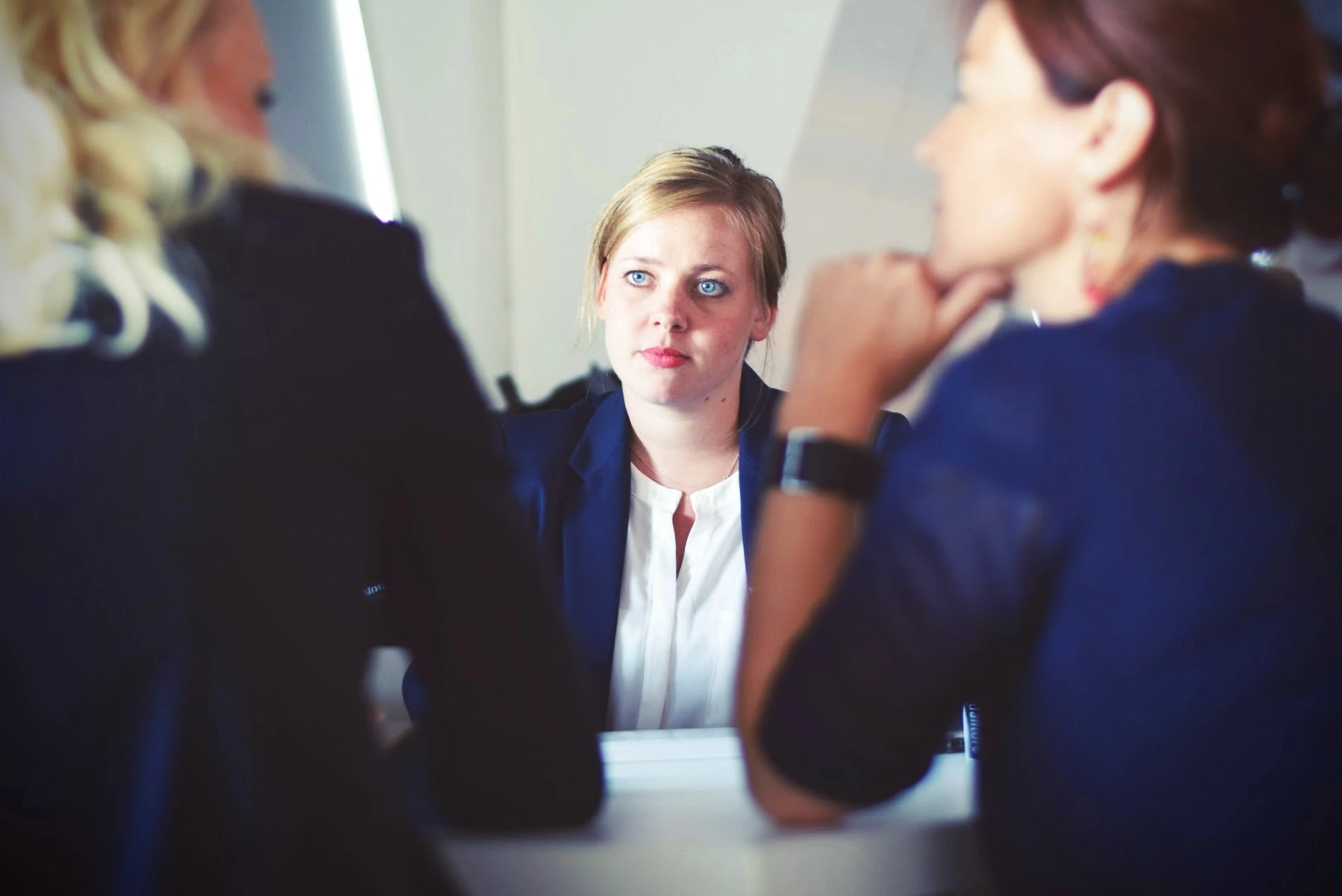 tim-gouw-3 business women negotiating at conference table unsplash