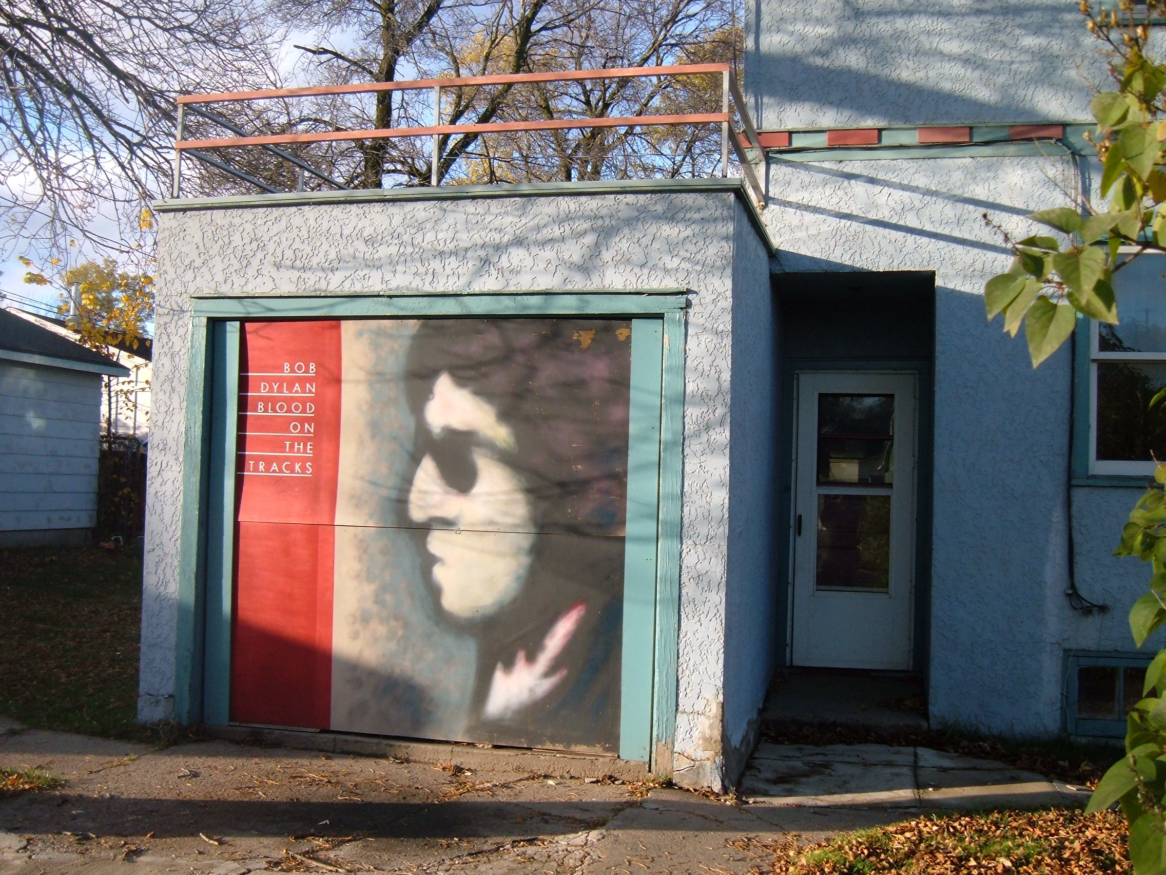 Blood on the Tracks garage painting, Bob Dylan's boyhood home (since removed) Blood on the Tracks garage painting, Bob Dylan's boyhood home (since removed) 7th Avenue...Hibbing, Minnesota...October 13, 2008. Photo by Christopher Eugene Lee