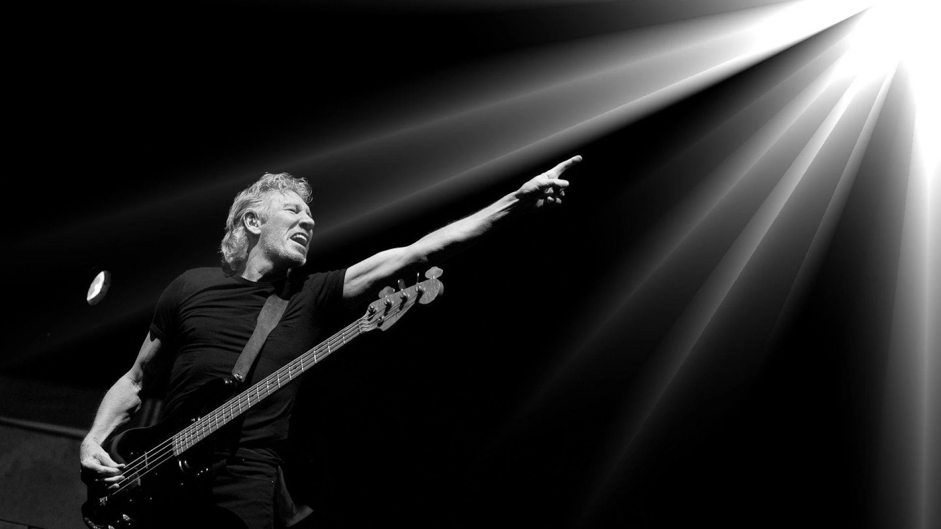 Roger Waters with bass pointing into light