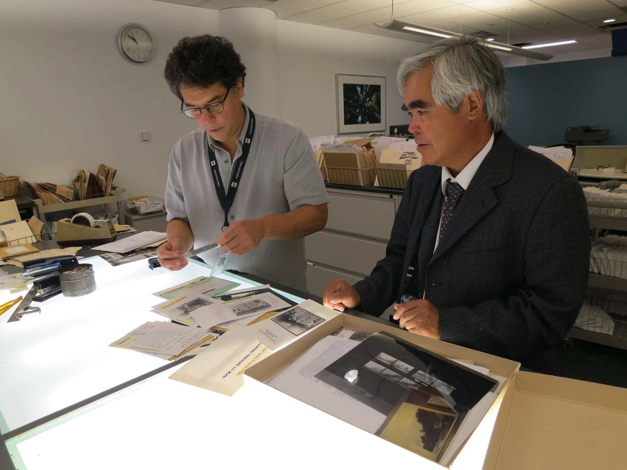Steve Ciaschi going thru negatives with Nick Ut, The AP photographer who shot the picture fo the Napalm Giril in Vietnam 1972 image by Chuck Zoeller, AP photographer