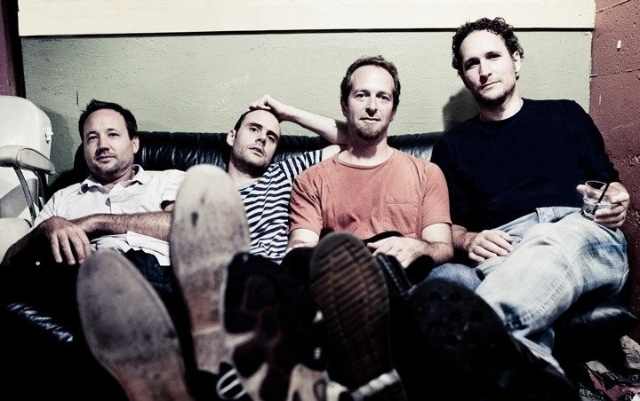 Mommyheads band member sitting on couch